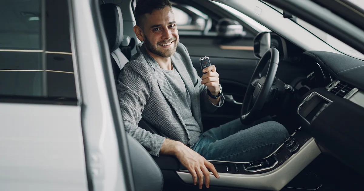 Happy man holding car keys after getting approved for a car loan in Canada