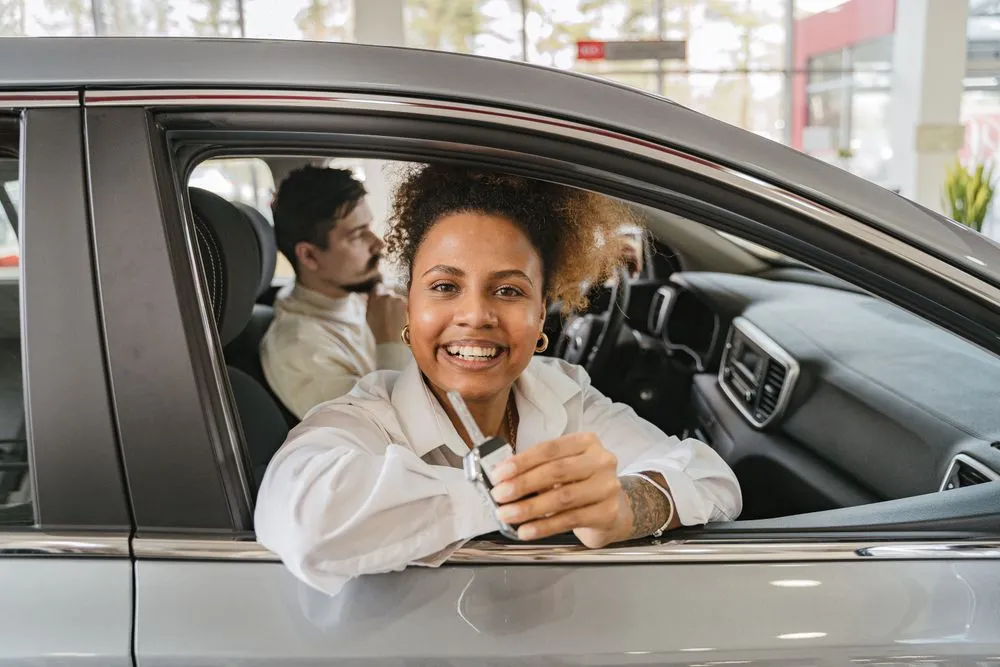 Approved for auto financing Canada: new owner holding the car keys