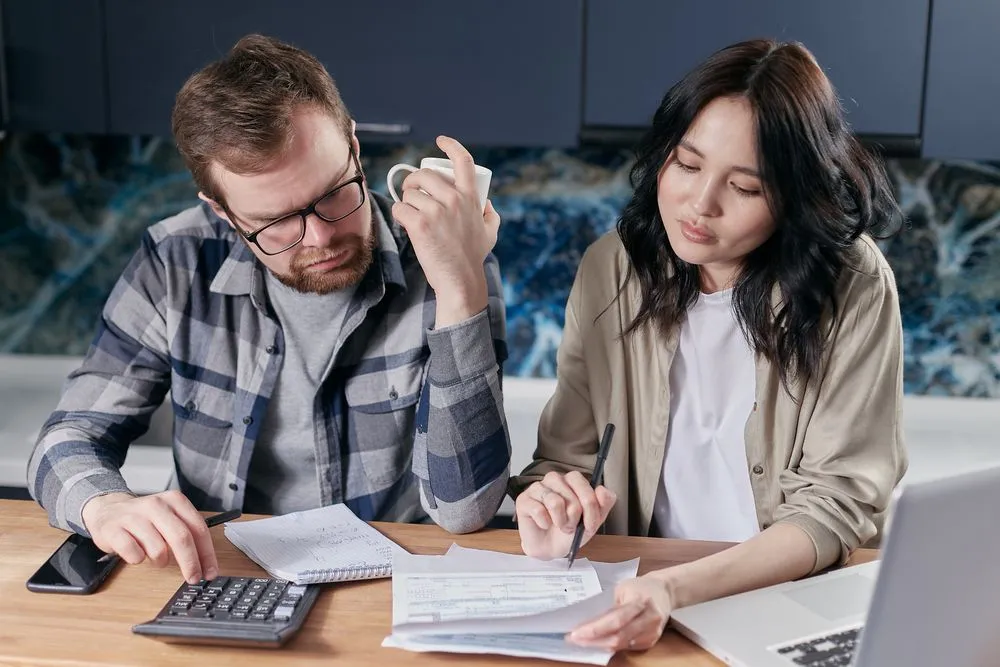 Planning an auto financing Canada budget with calculator and laptop