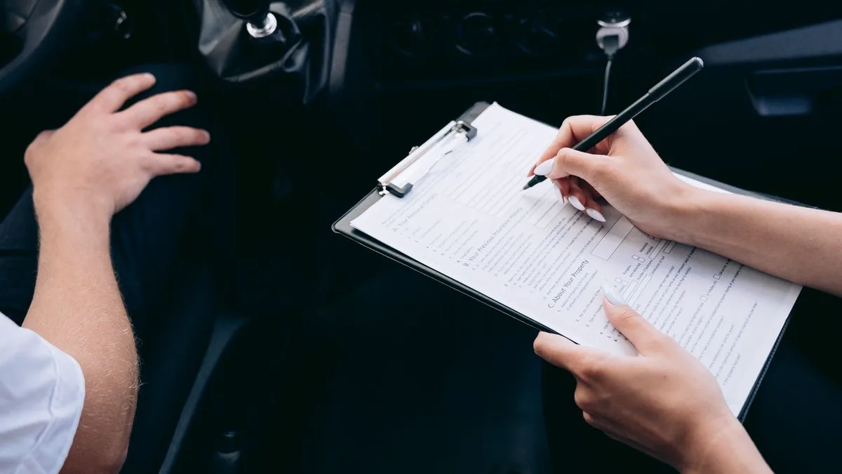 Signing a bill of sale for a private sale car financing purchase in Canada