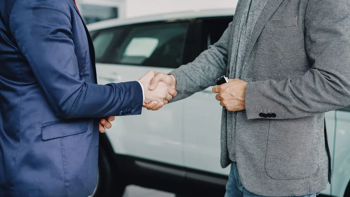 Car financing in Ontario finalized with a handshake at the dealership
