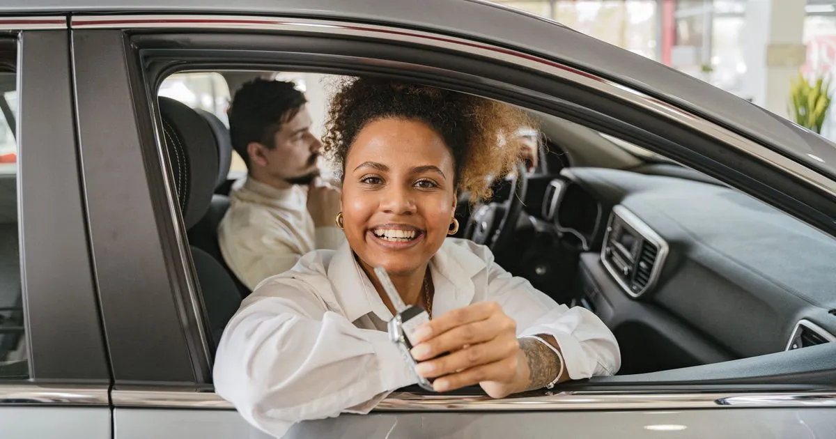 Car loans Ontario approval — happy buyer with keys to a new vehicle