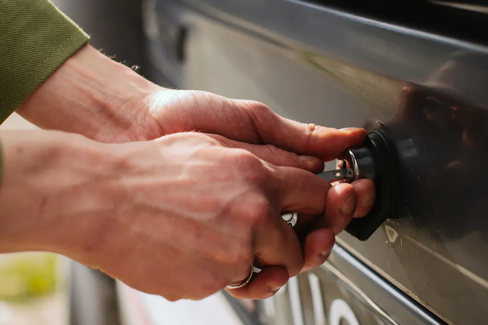 Person with a car key after getting financed again following a repossession in Canada