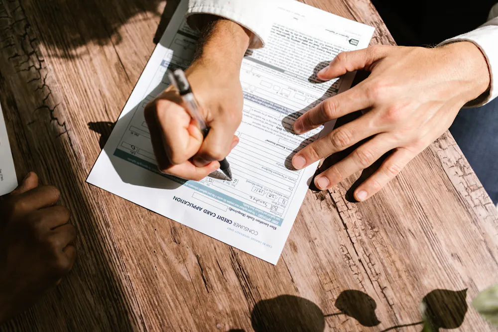 Filling out a car loan application form in Canada with no credit