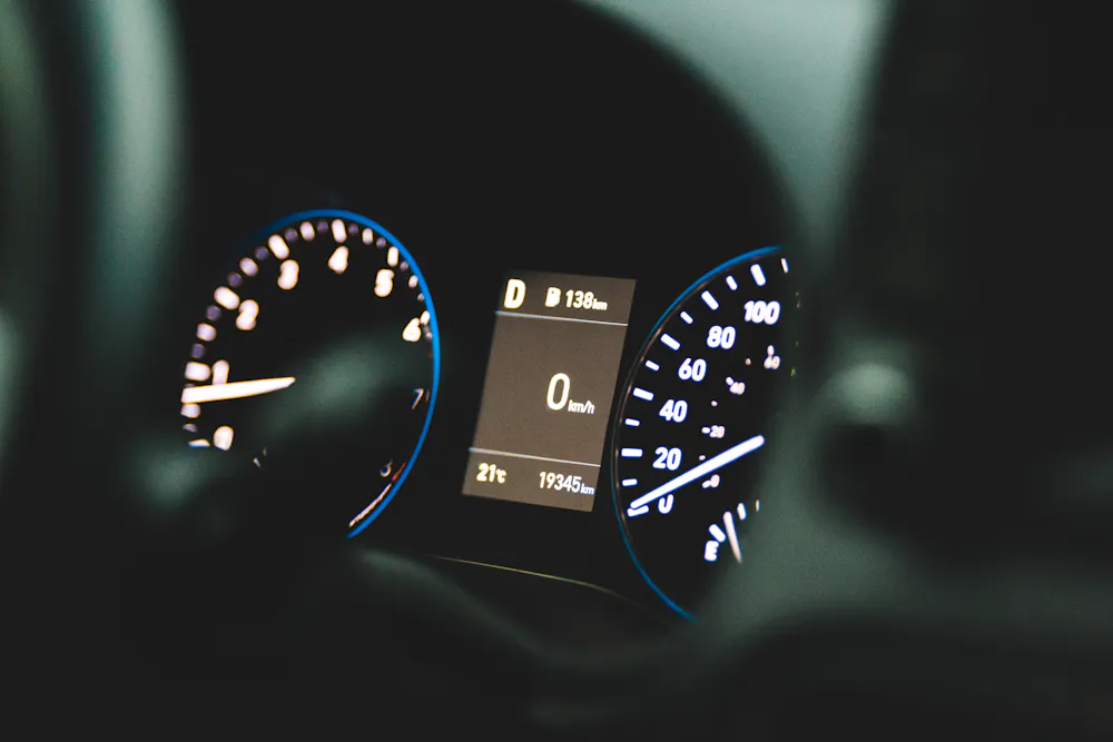 Checking a used car odometer showing kilometres in Canada