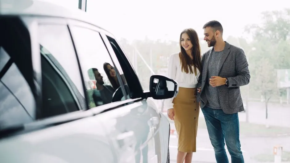Alberta couple choosing a vehicle at a dealership showroom