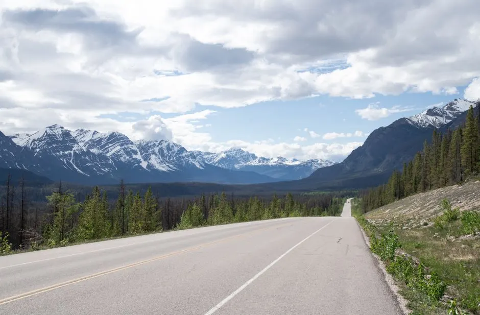 Driving an Alberta highway toward the Rocky Mountains