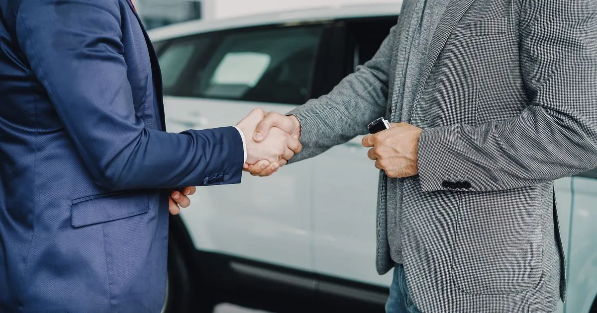 Car loan pre-approval Canada: buyer and dealer finalizing an approved agreement