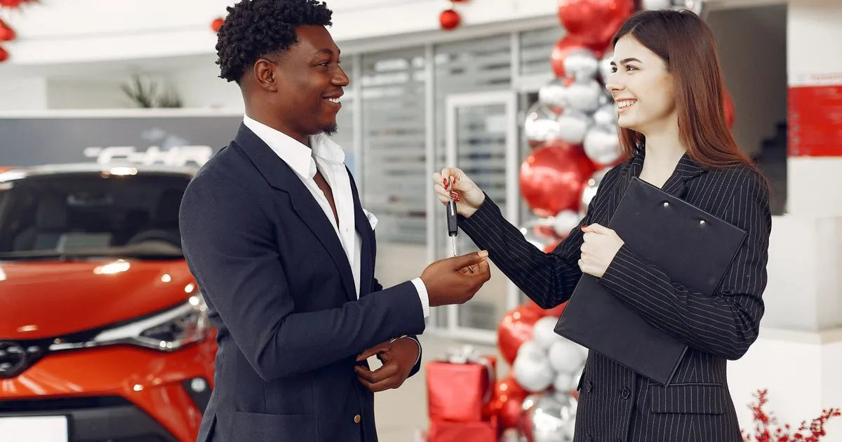 Customer approved for a car loan in Canada receiving the keys at a dealership