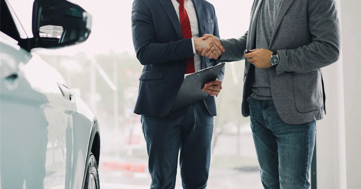 Credit union auto loan approved: buyer shaking hands and getting car keys