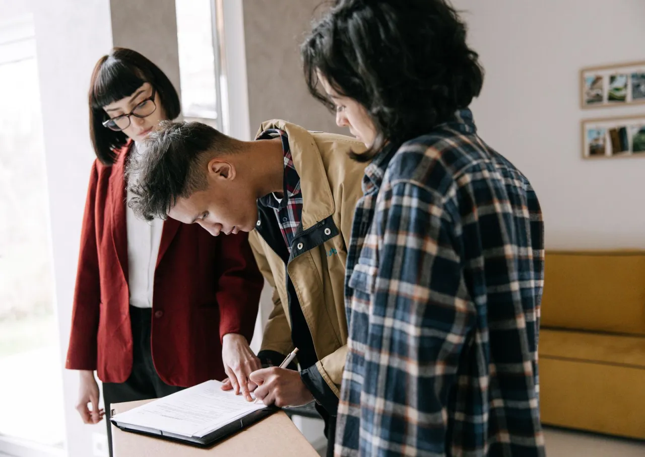 Signing a car loan agreement after comparing financing offers