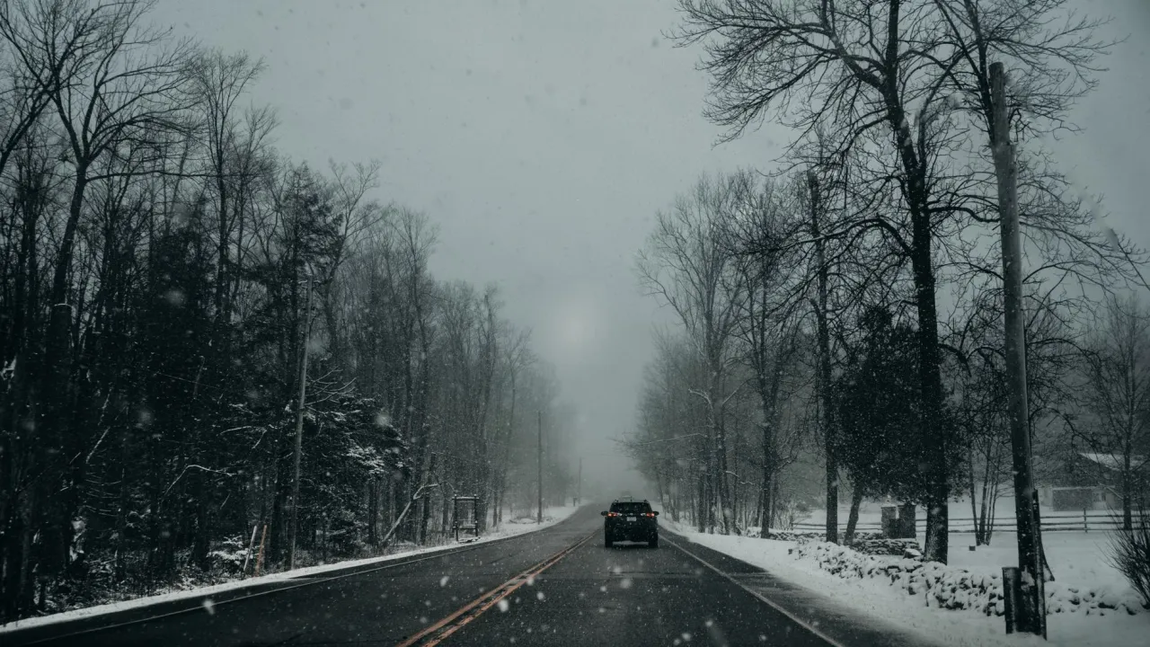 Winter driving on a snowy Ontario road where cold weather cuts EV range