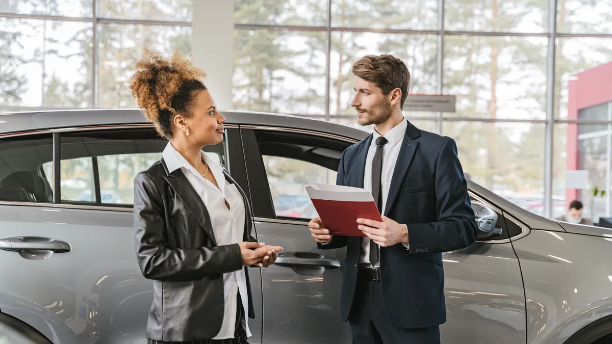 Bad credit car loans Canada: Ontario buyer reviewing the itemized bill of sale with a dealer